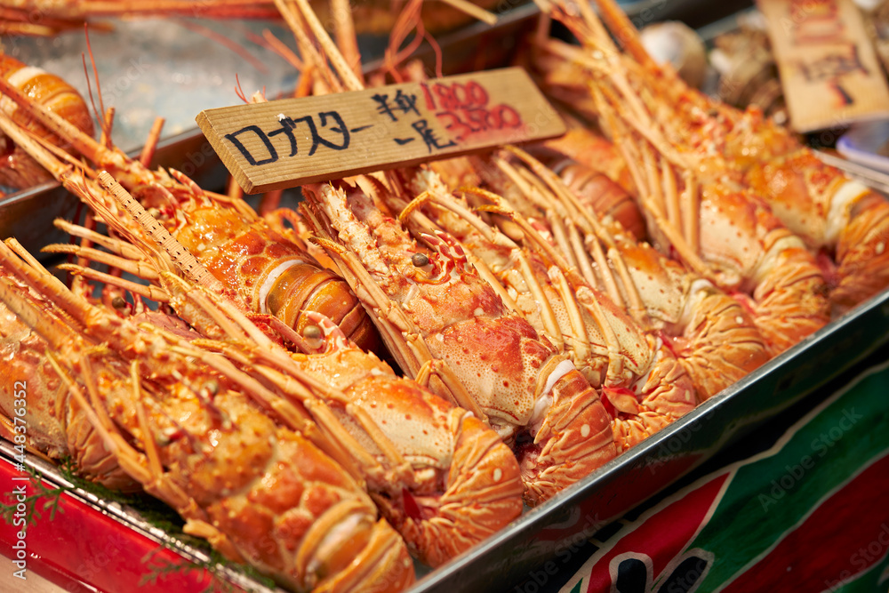 Lobstars on display with price boards on the market