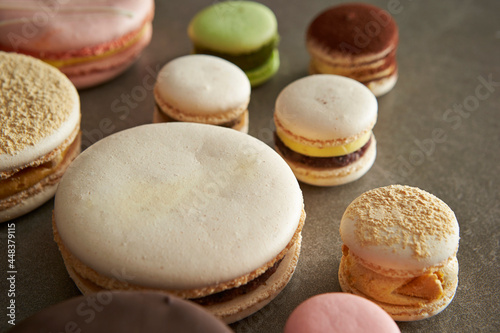 Different types of macarons on a gray background
