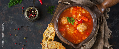 Spicy tomato soup with meatballs, pasta and vegetables. Healthy dinner. Top view, banner