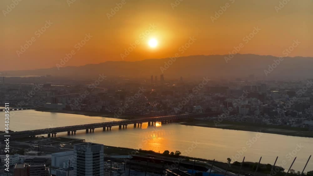 OSAKA, JAPAN : Aerial high angle sunset view of CITYSCAPE of OSAKA. View of buildings and street traffic around Yodogawa river. Wide view real time shot in dusk. OSAKA, JAPAN : Aerial high angle sunset view of CITYSCAPE of OSAKA. View of buildings and street traffic around Yodogawa river. Wide view real time shot in dusk.