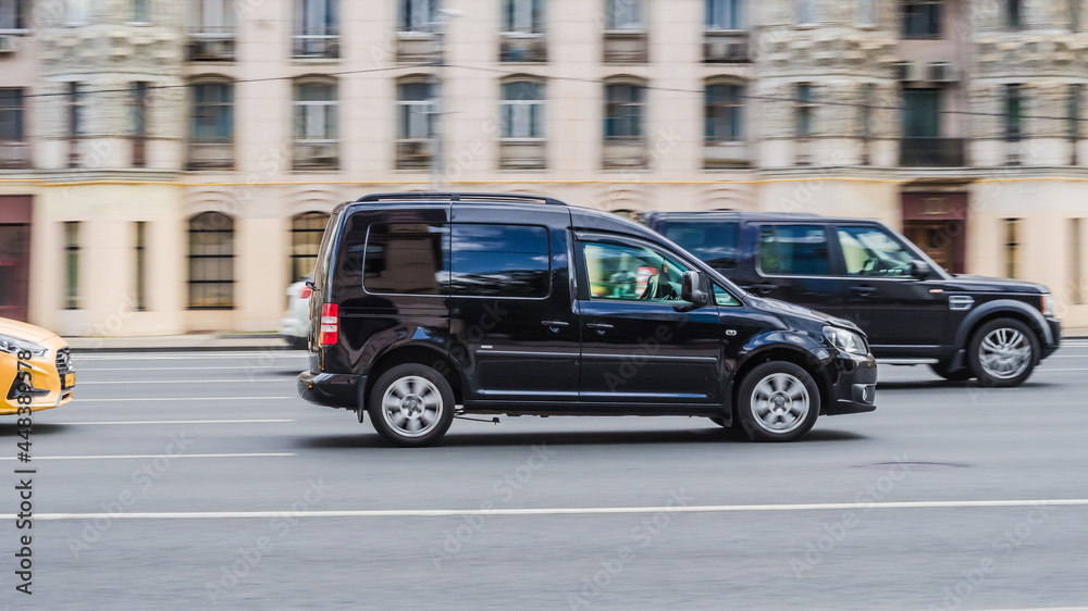 Volkswagen Caddy 2K first facelift in the motion on highway road. Compact  panel van at the city street Stock Photo