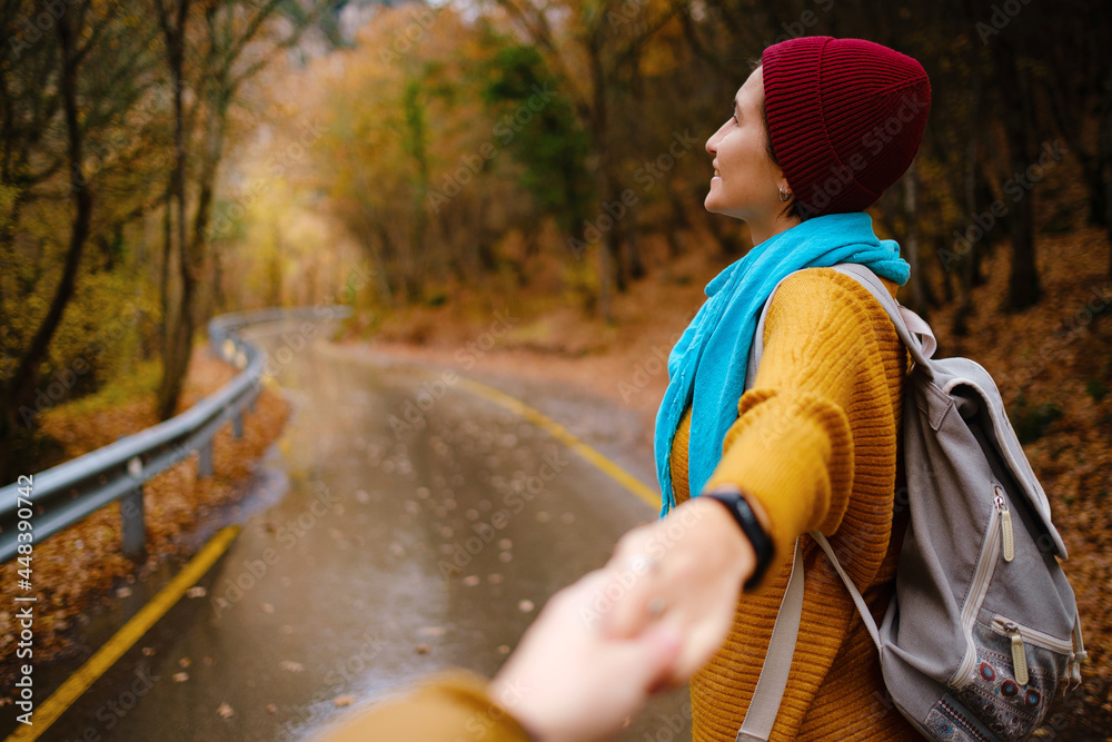 follow me concept woman in yellow sweater walking by road to forest follow me concept woman in yellow sweater walking by road to forest