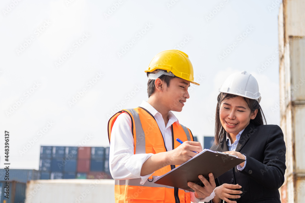 Selective focus at face Asian men worker. industrial warehouse container worker wearing safety workwear and taking with their supervisor while record data online with digital connection tablet. Selective focus at face Asian men worker. industrial warehouse container worker wearing safety workwear and taking with their supervisor while record data online with digital connection tablet.