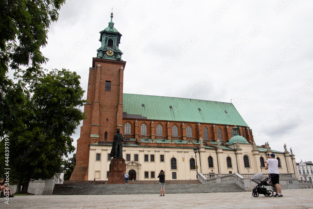 Gniezno, Poland - July 20, 2021: View of the monument to Boleslav I the Brave and of Cathedral Basilica of the Assumption of the Blessed Virgin Mary and St. Adalbert View of the monument to Boleslav