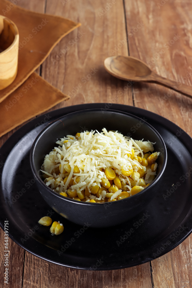 Jasuke, sweet corn snacks topping with grated cheese Jasuke, sweet corn snacks topping with grated cheese