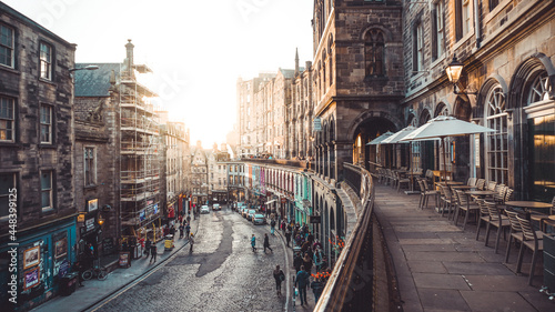 Very popular, busy and central street in the city of Edinburgh on a sunny evening. Quiet bar terrace for a drink.