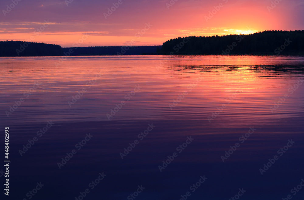 Colorful Dramatic sunset over the river. Sunset horizon over the forest, Natural landscape. Summer vacation concept. Beautiful natural background