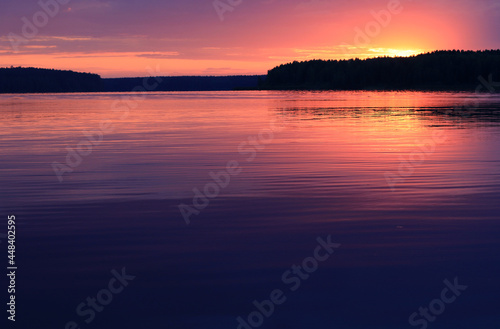 Colorful Dramatic sunset over the river. Sunset horizon over the forest, Natural landscape. Summer vacation concept. Beautiful natural background