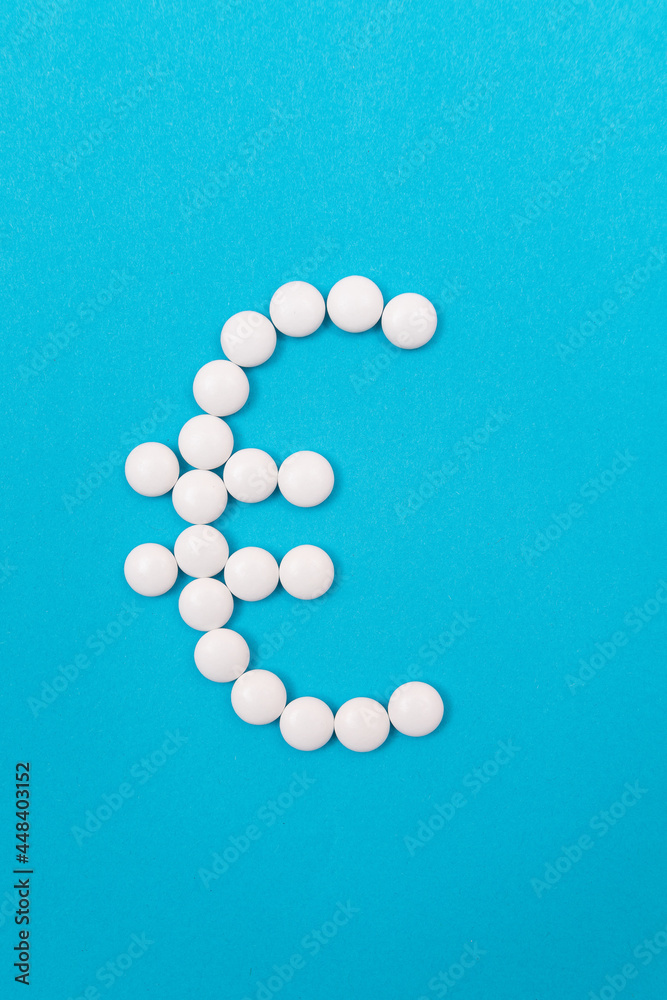 Global Pharmaceutical Industry and Medicine Business - Euro Symbol Made from White Pills Lying on Blue Background Global Pharmaceutical Industry and Medicine Business - Euro Symbol Made from White Pills Lying on Blue Background