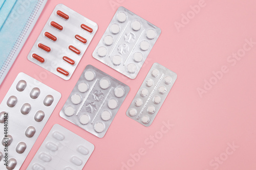 Different Pills and Tablets Package on Pink Background. Top View, Flat Lay