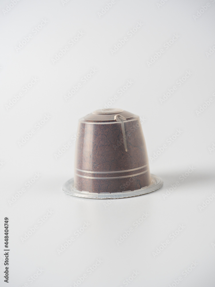 a plastic capsule with ground coffee on a white background. Non eco friendly packaging that cannot be reused a plastic capsule with ground coffee on a white background. Non eco friendly packaging that cannot be reused
