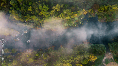 amazing aerial view of foggy morning river and colorful trees. drone shot