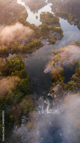 amazing aerial view of foggy morning river and colorful trees. drone shot