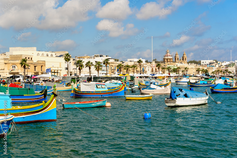 Traditional Luzzu fishing boats moored at Marsaxlokk harbor, Malta