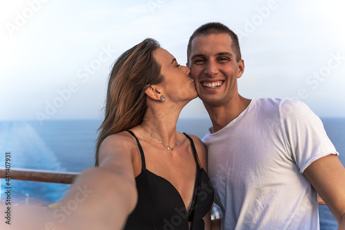 young couple taking a selfie from a cruise ship during sailing