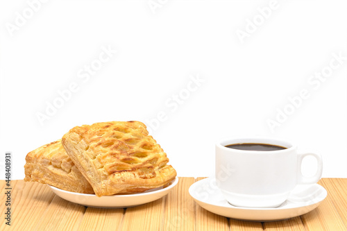 black coffee in white seramic glasses and pineapple pie on wooden table