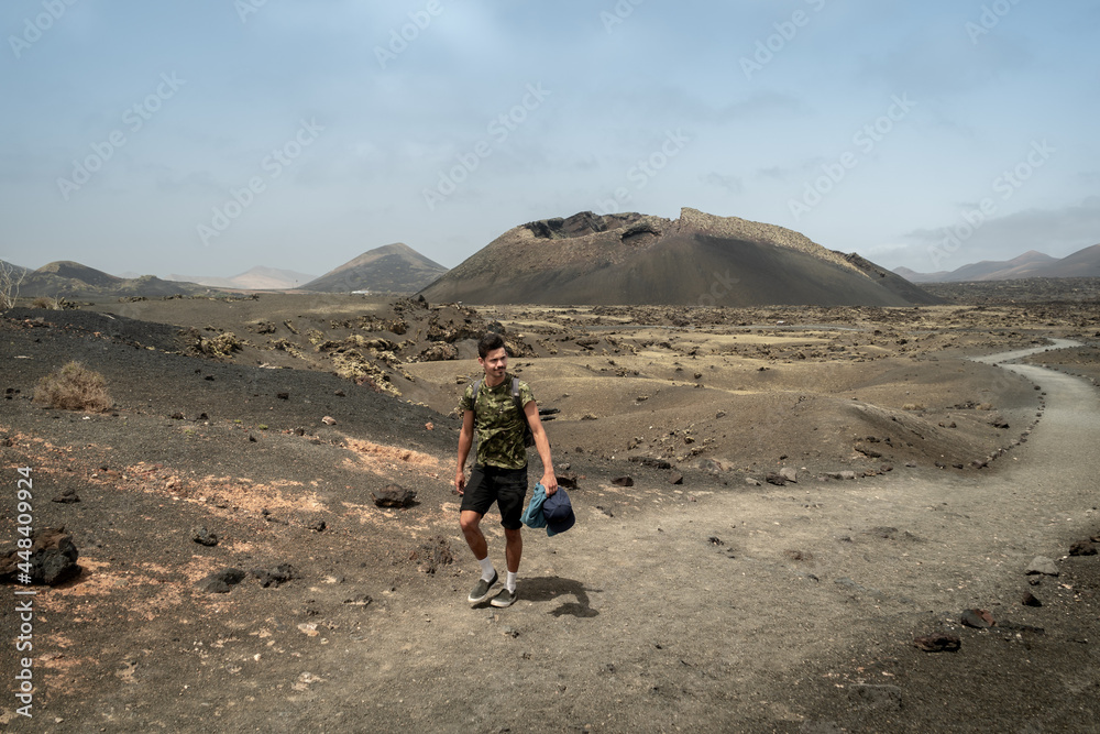 young man walks along a path in Masdache with young man walks along a path in Masdache with