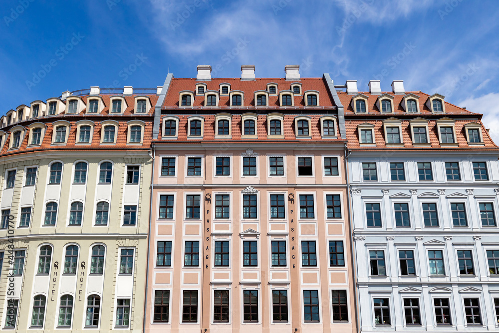 Renovated buildings on new market, sunny summer day. a pink and light blue house right next to each other. QF Passagen in Dresden's old town. 