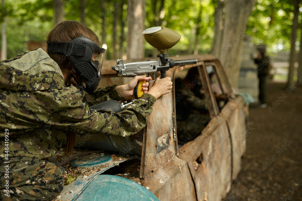 Fototapeta premium Paintball player in uniform and mask in forest
