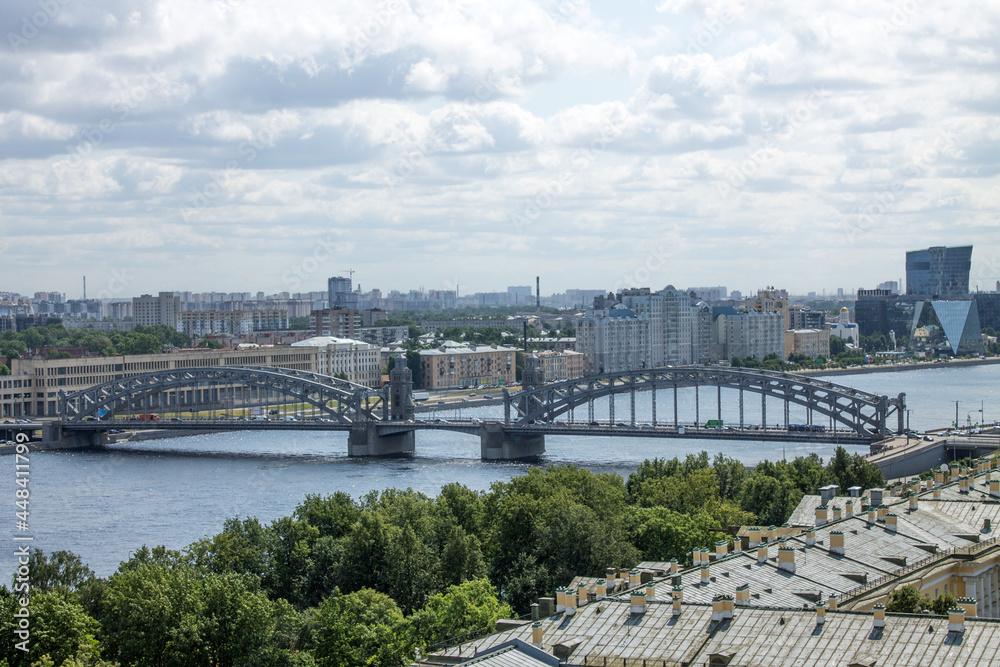 panoramic top view of the Bolsheokhtinsky metal bridge over the Neva River and the roofs of houses on a sunny summer day in Saint-Petersburg  Russia