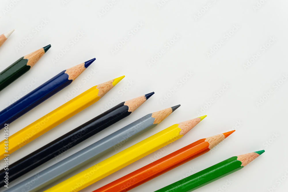 Multi-Colored Pencils Lie on a Light Background. Multi-Colored Pencils Lie on a Light Background.