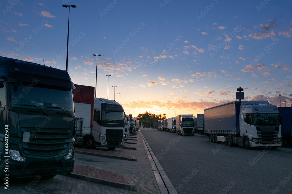 Sun rises over a truck parking lot on the highway Sun rises over a truck parking lot on the highway