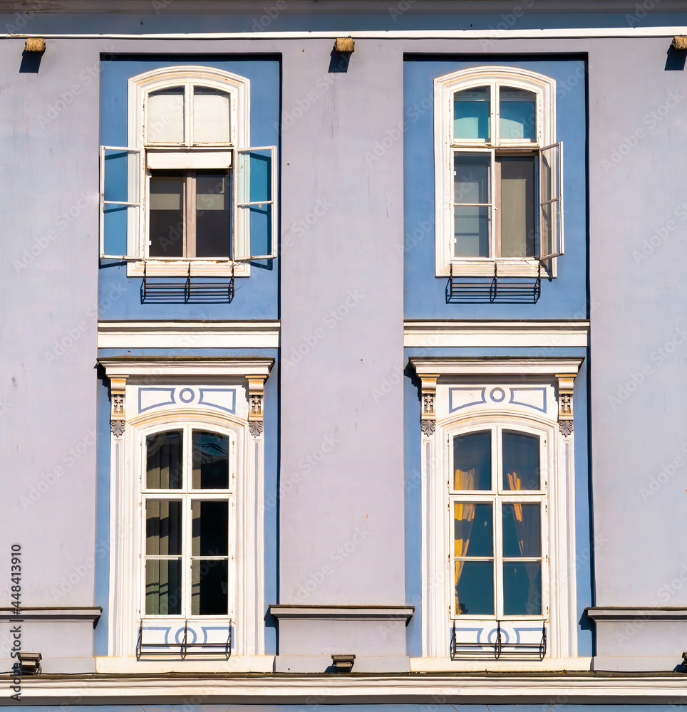 Architectural detail of two blue colored wooden framed windows