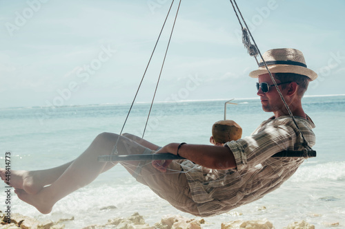 man drinking coconut on the tropical beach at summer day © karyakinvitaliy