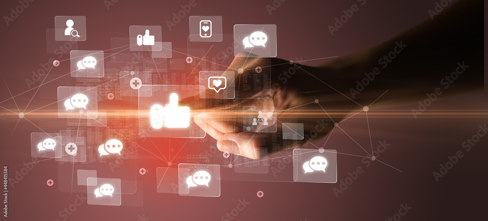 Hand pressing social media multimedia application screen with media icons on futuristic concept Hand pressing social media multimedia application screen with media icons on futuristic concept