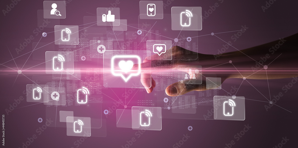 Hand pressing social media multimedia application screen with media icons on futuristic concept Hand pressing social media multimedia application screen with media icons on futuristic concept