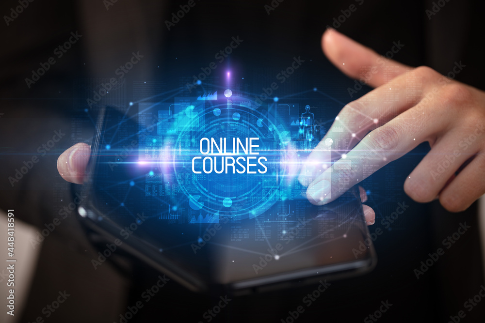 Fototapeta premium Young man holding a foldable smartphone