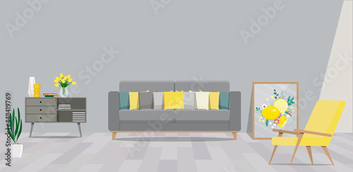 Interior of a room in restrained gray tones with a sofa, an armchair and a painting