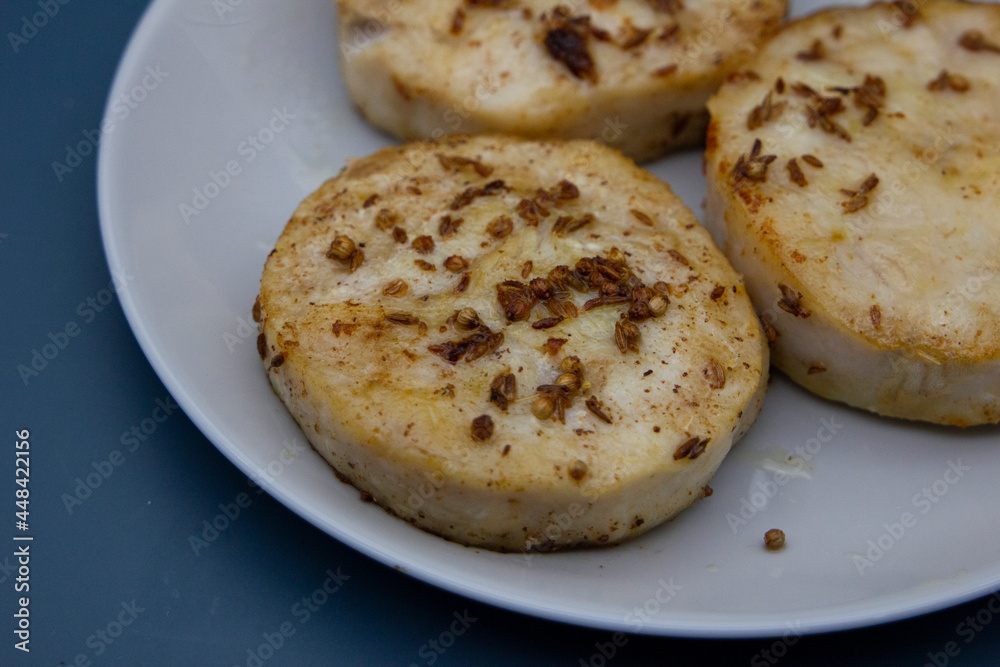 Pan-fried hake fish in the form of medallion fillets sprinkled with cumin and coriander spices. Pan-fried hake fish in the form of medallion fillets sprinkled with cumin and coriander spices.
