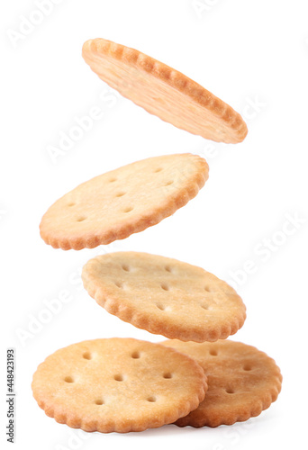 Round crackers fall on a heap on a white background. Isolated photo