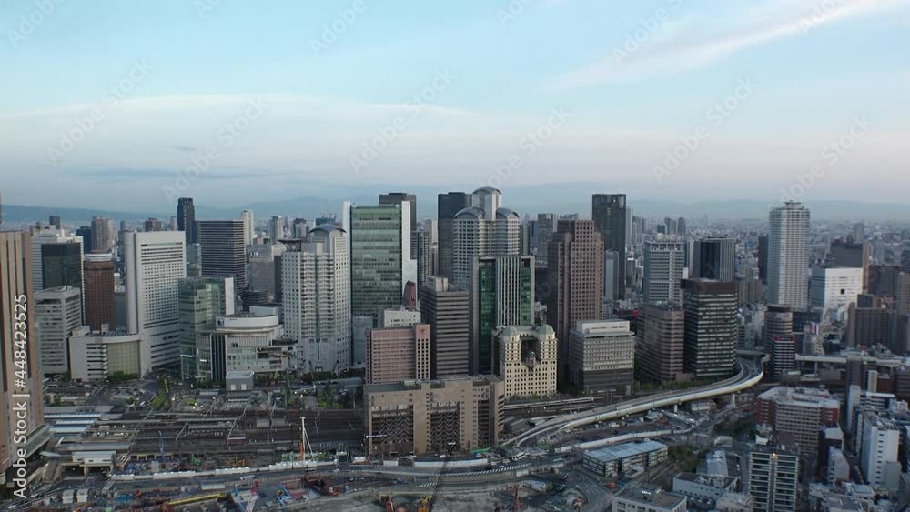 UMEDA, OSAKA, JAPAN : Aerial high angle sunset view of CITYSCAPE of OSAKA. View of buildings and street around Osaka and Umeda station. Wide view time lapse shot, dusk to night. UMEDA, OSAKA, JAPAN : Aerial high angle sunset view of CITYSCAPE of OSAKA. View of buildings and street around Osaka and Umeda station. Wide view time lapse shot, dusk to night.