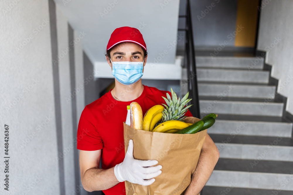 Food delivery service, male worker holding grocery bag, express food order Food delivery service, male worker holding grocery bag, express food order
