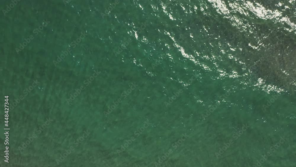 Top down aerial view of calm teal color sea surface. Soothing look at water. Natural abstract background. Top down aerial view of calm teal color sea surface. Soothing look at water. Natural abstract background.