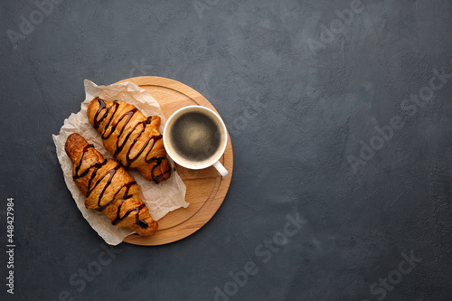 Breakfast - coffee and sweet croissant with chocolate. Flat lay.