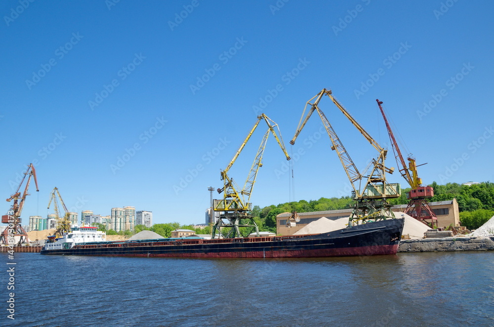 The Moscow Canal. Port cranes and a barge at the Northern River Station in Moscow, Russia