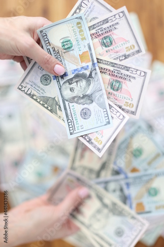 Woman is holding lot of cash American money closeup