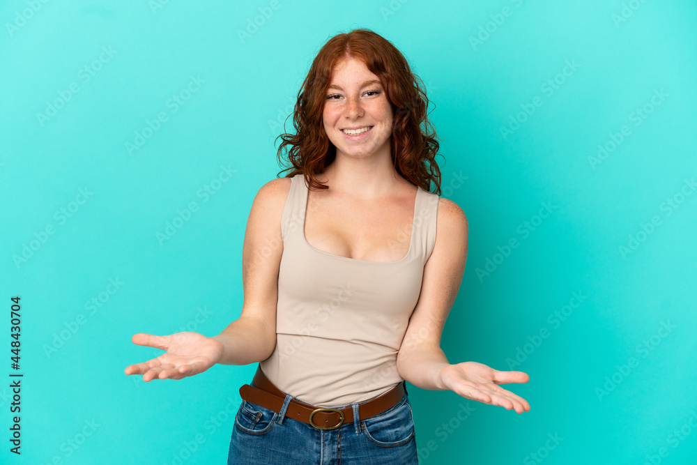 Teenager reddish woman isolated on blue background happy and smiling Teenager reddish woman isolated on blue background happy and smiling