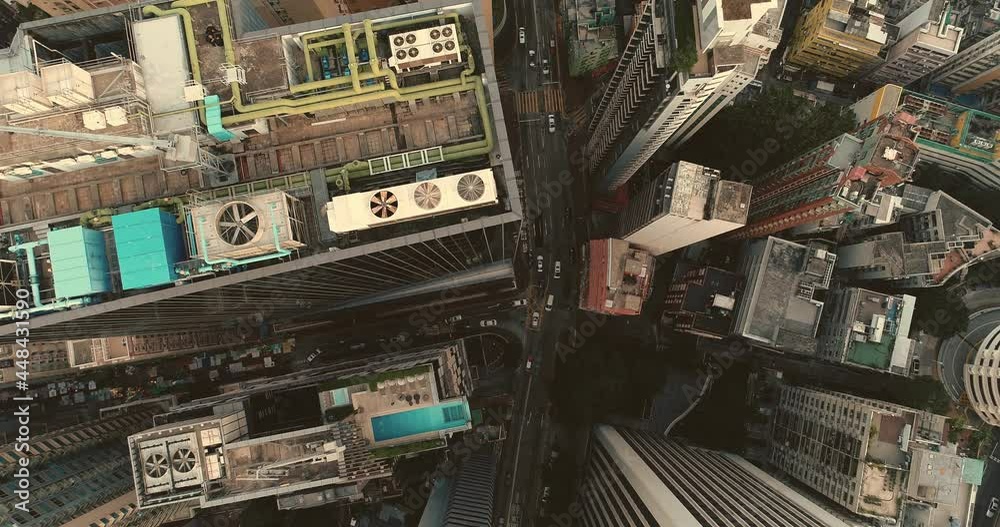 AERIAL. Hong Kong Vertical view flying over city centre with close up view of the buildings. Cinematic urbane footage. AERIAL. Hong Kong Vertical view flying over city centre with close up view of the buildings. Cinematic urbane footage.