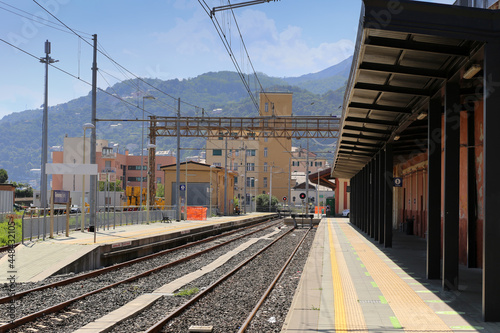 Railway track with terminal stop in a secondary station of Genoa Voltri city against mountains background. italy