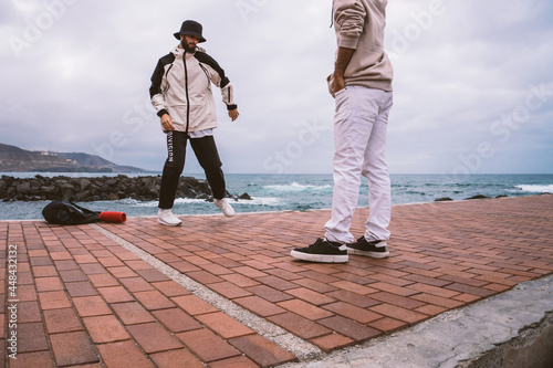 Canvas Print Two Caucasian guys, dressed in casual outfits, dance shuffle in the middle of th