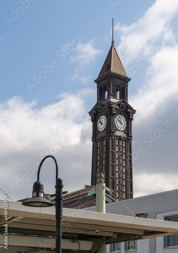 Hoboken, NJ - USA - July 30, 2021: Vertical view of the clock tower of New Jersey Transit's historic Hoboken Terminal. photo