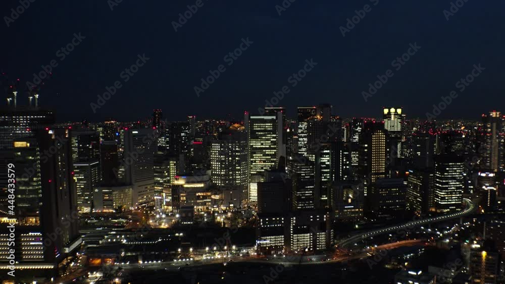 UMEDA, OSAKA, JAPAN : Aerial high angle sunrise view of CITYSCAPE of OSAKA. View of buildings and street around Osaka and Umeda station. Wide view time lapse shot, night to morning. UMEDA, OSAKA, JAPAN : Aerial high angle sunrise view of CITYSCAPE of OSAKA. View of buildings and street around Osaka and Umeda station. Wide view time lapse shot, night to morning.