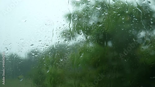 Raindrops through the glass. Storm, hurricane and strong wind through the glass