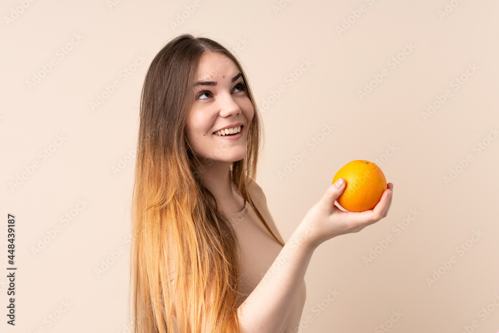 Young caucasian woman holding an orange Young caucasian woman holding an orange