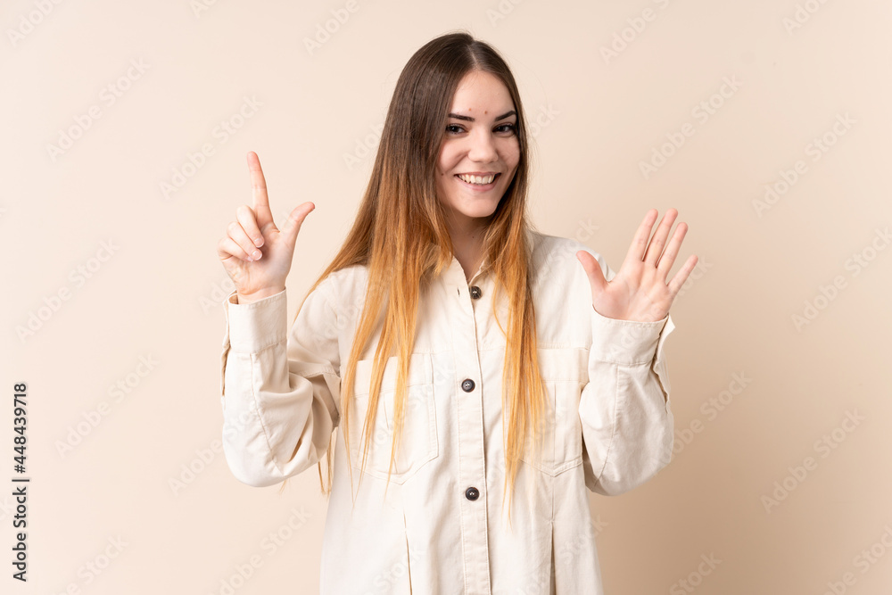 Young caucasian woman isolated on beige background counting seven with fingers Young caucasian woman isolated on beige background counting seven with fingers