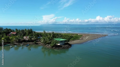 house with green roof on Zancudo peninsula aerial view sunny day corcovado in background Costa Rica photo